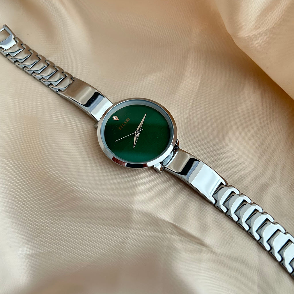 Silver Body wristwatch with silver strap on soft fabric background.