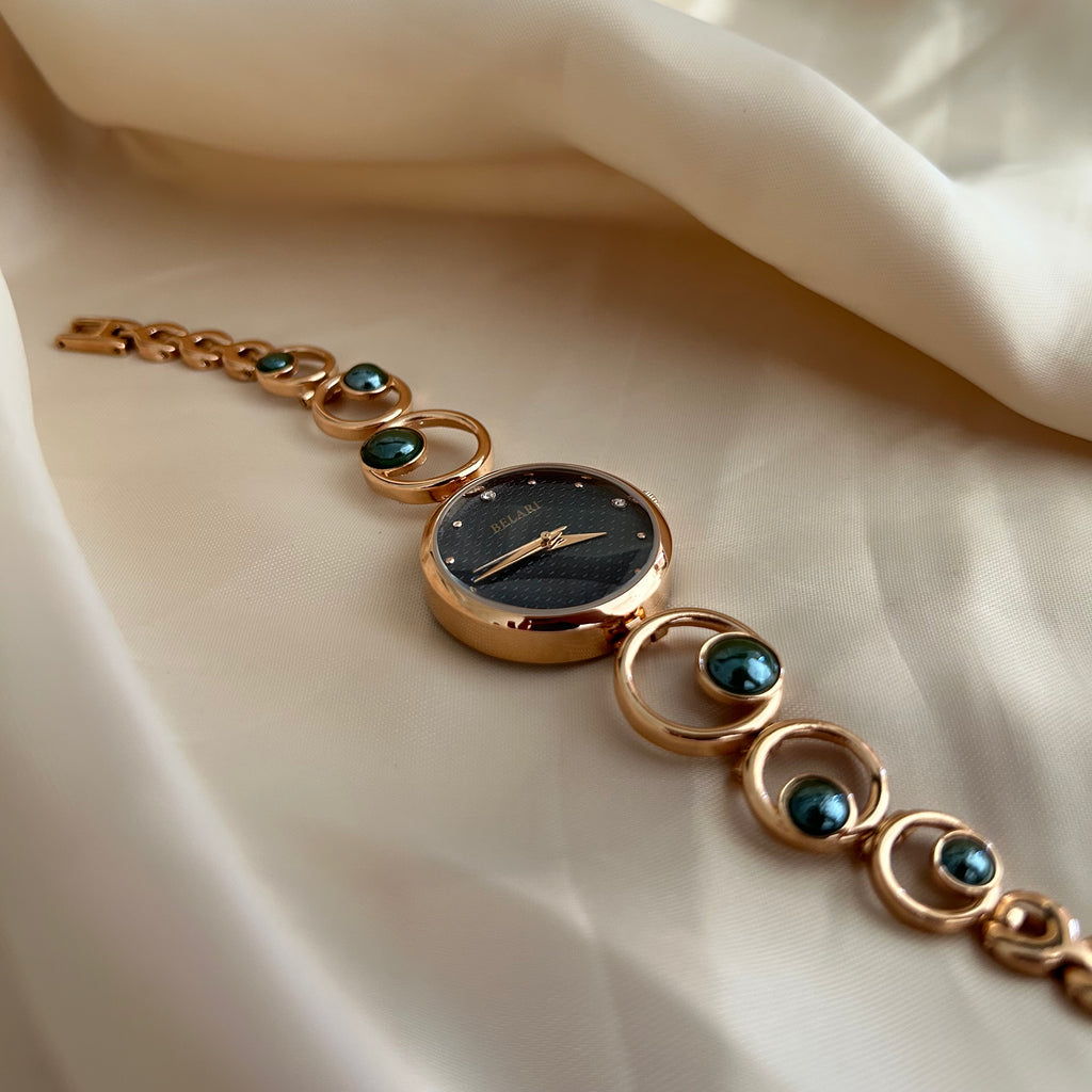 Rose gold wristwatch with pearl bracelet design and round dial on soft satin background.
