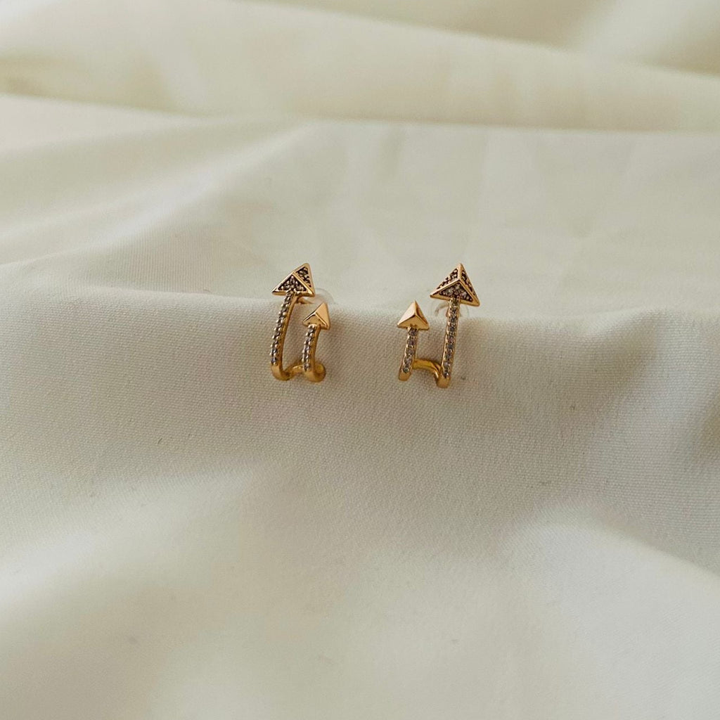 Stylish arrow-shaped gold earrings with crystals.