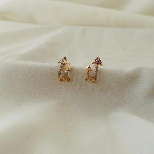 Stylish arrow-shaped gold earrings with crystals.